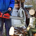 "Chainsaw in use with proper safety gear"